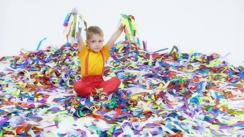 Cheerful boy playing with colorful ribbons at children's party Stock Footage 79155181