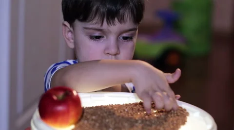 Cheerful boy playing with  red apples. Stock-Footage 60420244