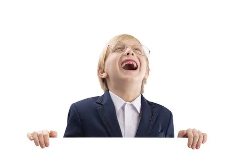 Cheerful boy posing with empty white paper board and laughs. Cute blond boy p Stock-Fotos