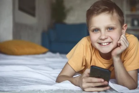 Cheerful boy using digital device Stock Photos