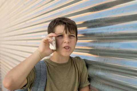 Cheerful boy using a mobile phone Stock Photos