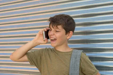 Cheerful boy using a mobile phone Stock Photos