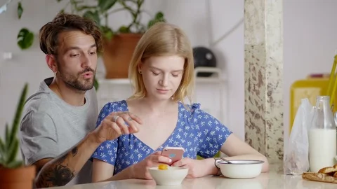 Cheerful boyfriend coming from back pulls hand to eat breakfast of shocked Stock Footage 108796707