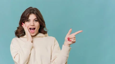 Cheerful Brunette Pointing to the Camera in Studio Stock Footage 234135467