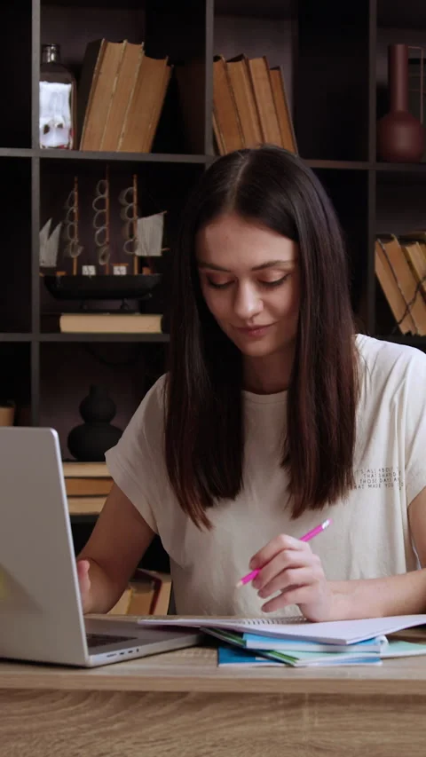Cheerful brunette student preparing a project using a computer and the internet. Video stock 305406638