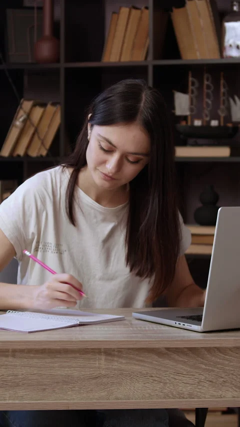 Cheerful brunette student preparing a project using a computer and the internet. Stock Footage 305406966