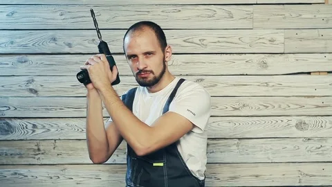 Cheerful Builder with screwdriver Stock Footage 82973592