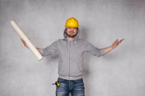 Cheerful builder throws up his hands in a gesture of victory Stock Photos