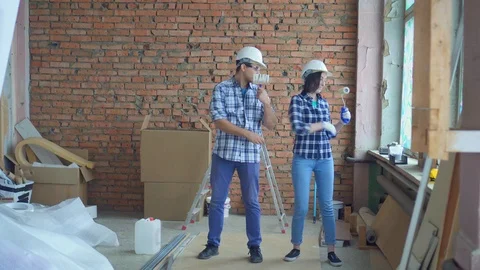Cheerful builders are dancing during the repair Video stock 99537494
