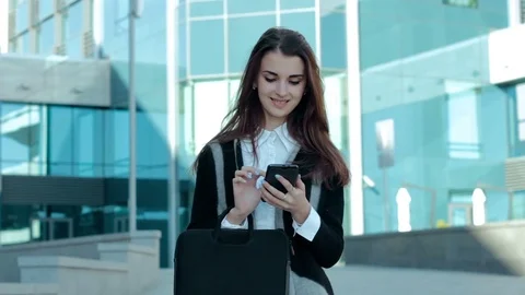 Cheerful business girl working with mobile phone Stock Footage