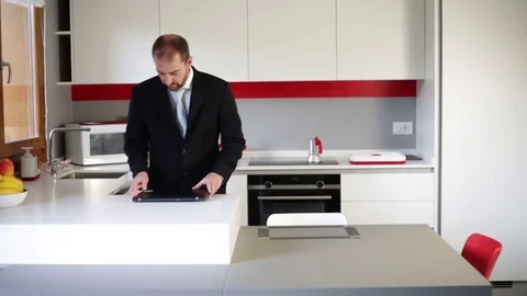 Cheerful businessman dancing in the kitchen. Drinking wine at the end of the Stock Footage 116346832
