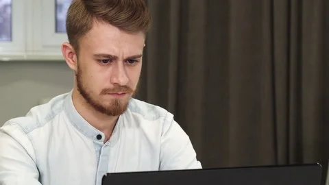 Cheerful businessman smiling to the camera while working on the computer Stock Footage 85104194