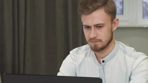 Cheerful businessman smiling to the camera while working on the computer Stock Footage 311991932