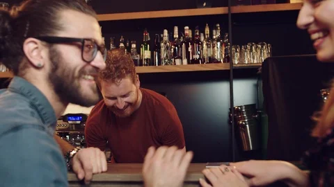 Cheerful caucasian bartender serving customers. Pub interior. Stock Footage 125083069
