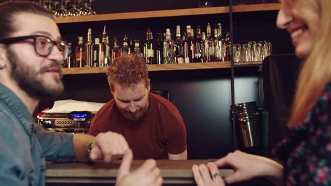 Cheerful caucasian bartender serving customers. Pub interior. Stock Footage 125085590
