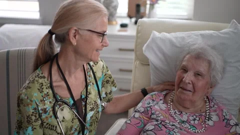 Cheerful Chat Between Nurse and Elderly Woman at Health Check Stock Footage 313347290