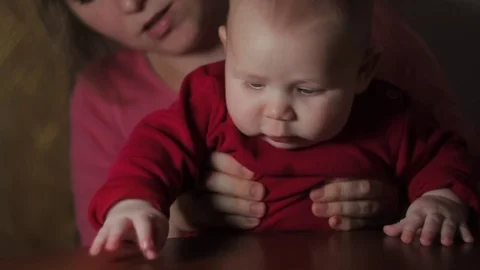 Cheerful Child With Grey Eyes Exploring World Sitting on Mother's Lap Stock Footage 71896030
