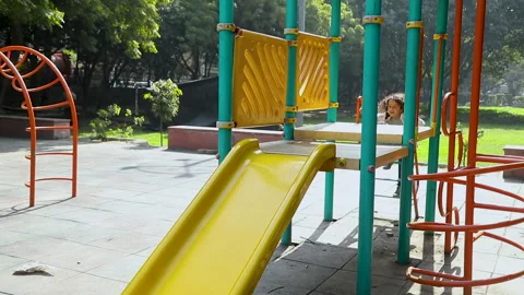 Cheerful Children Roll Down The Yellow Slide On The Playground 스톡 동영상 239327641