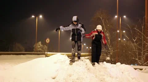 Cheerful Children Running Down the Snow Hill Stock Footage 10734330