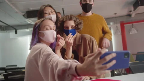 Cheerful classmates are taking funny photos together, sitting in the audience Stock Footage 175473686