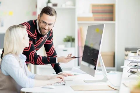 Cheerful colleagues discussing app development Stock Photos