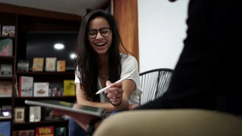 Cheerful colleagues discussing data on tablet Video stock 146603633