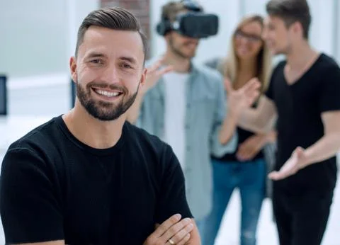 Cheerful colleagues testing virtual reality glasses Foto stock