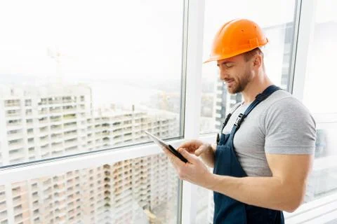 Cheerful construction engineer using tablet Stock Photos