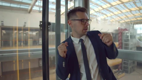 Cheerful corporate worker dance in empty glass elevator Stock Footage 220918650