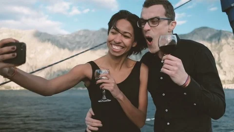 Cheerful couple drinking wine and making funny selfie phone. Stock Footage 76799227