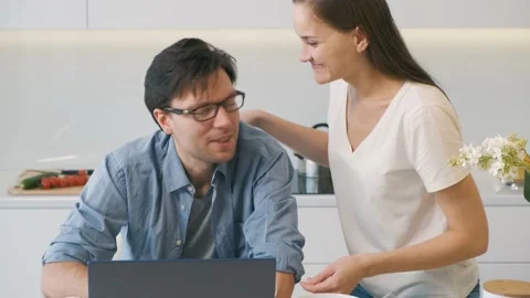 Cheerful couple looking at screen of laptop Stock Footage 149198357