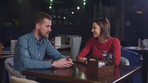 Cheerful couple with menu in a restaurant making order Stock Footage 70441716