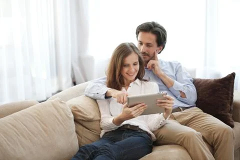 Cheerful couple using tablet Stock Photos