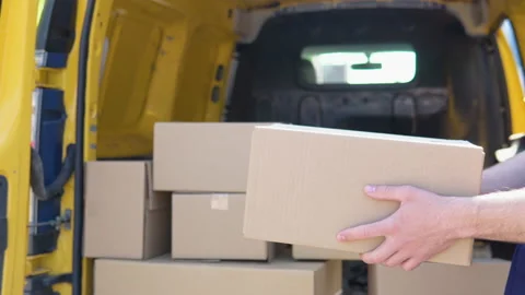 Cheerful courier throws the parcel standing near delivery van Stock Footage 193437252