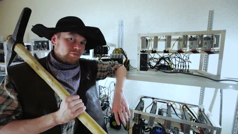 Cheerful cryptocurrency miner with pickaxe Stock Footage 87045592