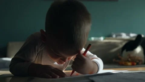 Cheerful cute small kid boy artist playing alone drawing with pencils Video stock 165844337