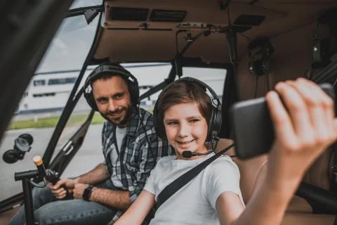 Cheerful dad and boy using digital device Stock Photos