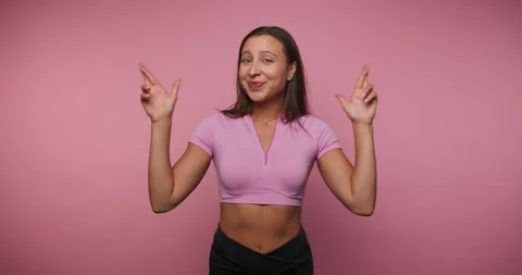 Cheerful dancer expresses joy through movement and gestures in a pink backg.. Stock Footage 317397682