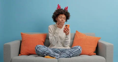 Cheerful dark skinned curly young woman dressed in casual clothes and New Year Stock Footage 144047513