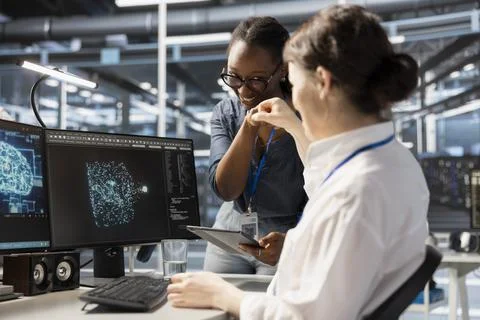 Cheerful data center admins doing fist bump, celebrating AI implementation Foto stock
