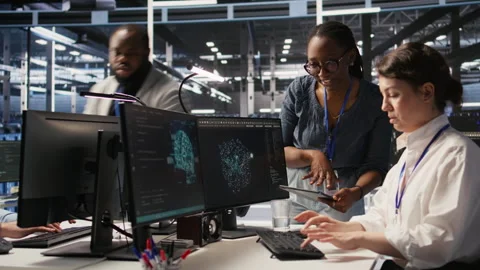 Cheerful data center engineers doing fist bump after completing AI deployment Stock Footage 309782156