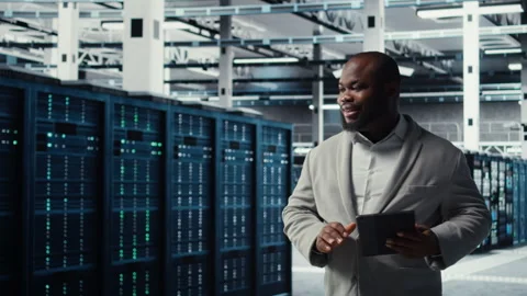 Cheerful data center programmer using tablet to manage software updates Stock Footage 311833135