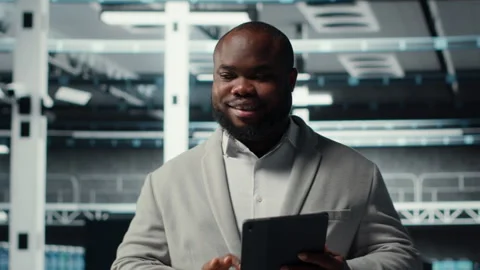 Cheerful data center programmer using tablet to manage software updates Stock-Footage 311959962