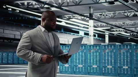 Cheerful data center system administrator reviews code for automation scripts Stock Footage 311897615