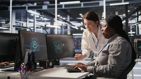 Cheerful data center technicians collaborating on AI automation deployment Stock Footage 309785125