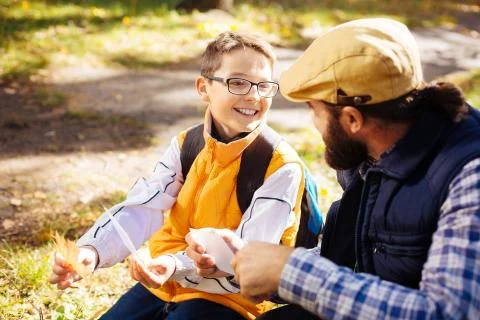 Cheerful delighted boy holding a maple leaf Foto stock