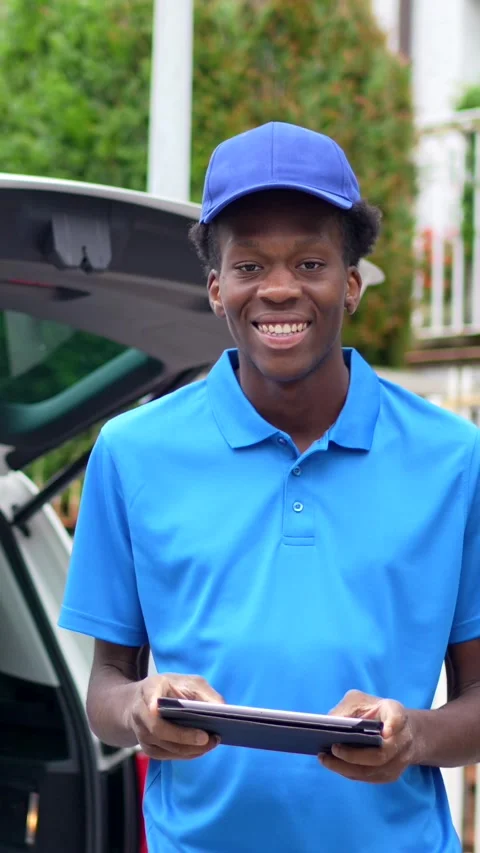 Cheerful delivery african man using tablet while working with van Stock Footage 284511113