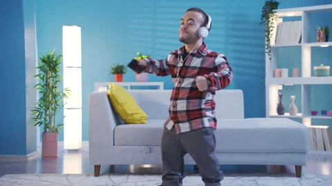 Cheerful disabled dwarf young man dancing while listening to music  Stock Footage 230973875