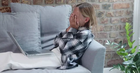 Cheerful distracted student using laptop while sitting on sofa at home Stock Footage 271320413
