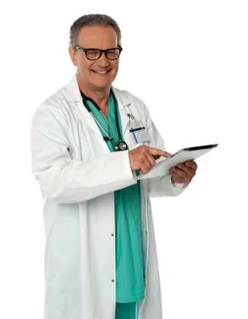 Cheerful doctor using wireless tablet device Stock Photos